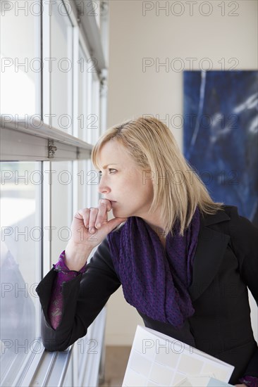 Caucasian woman looking out window