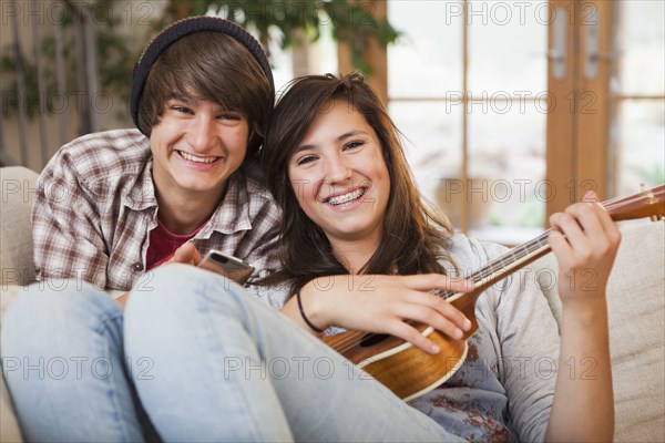 Mixed race couple sitting on sofa