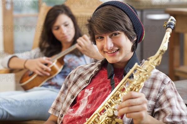 Mixed race teenagers playing musical instruments