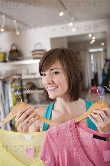 Hispanic woman shopping in clothing store