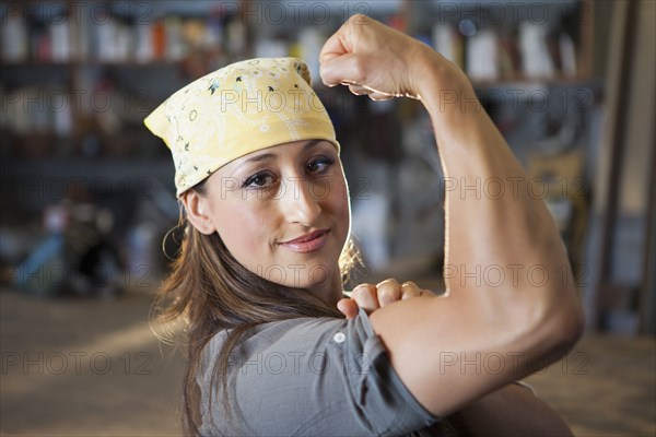 Hispanic worker flexing biceps