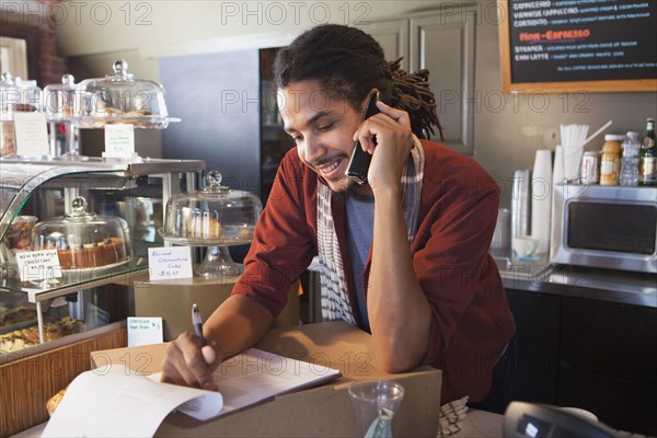 Mixed race man working in coffee shop