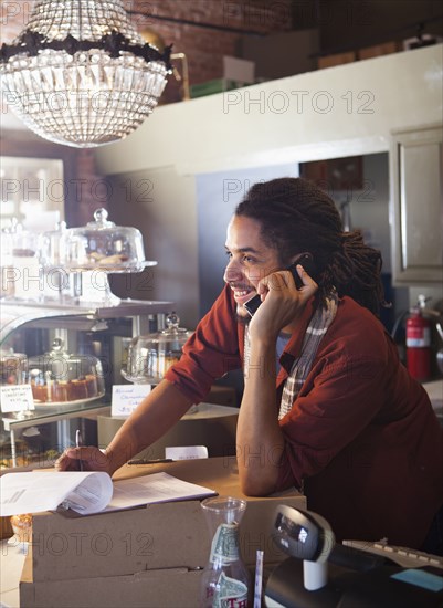 Mixed race man working in coffee shop