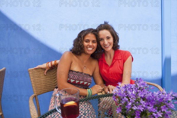 Friends sitting at patio table together