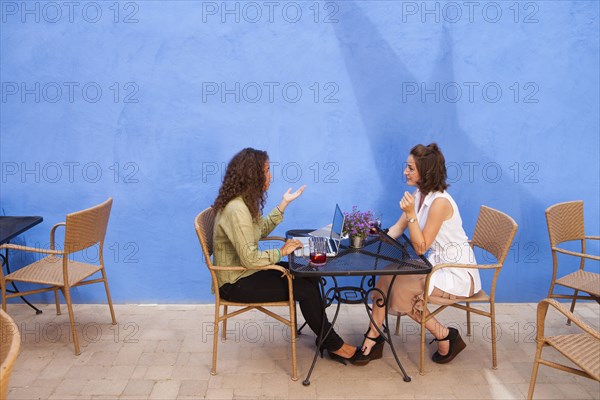 Businesswomen having meeting in outdoor cafe