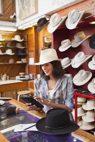 Ecuadorian woman working in hat store