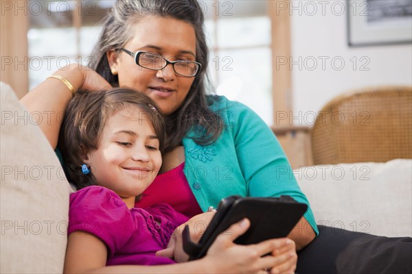 Mother and daughter using digital tablet