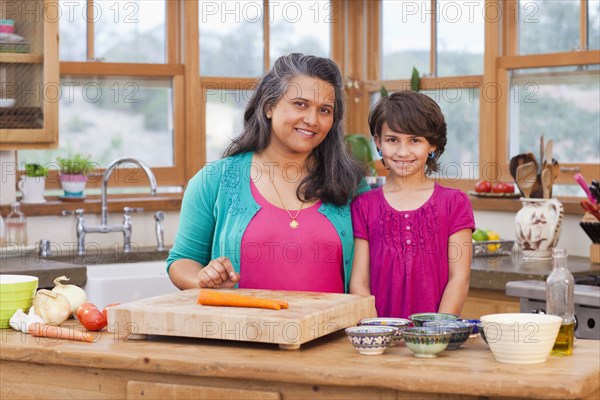 Mother and daughter cooking in kitchen