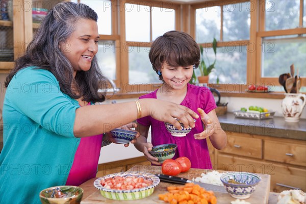 Mother and daughter cooking in kitchen