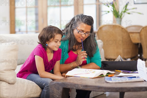 Mother helping daughter with homework