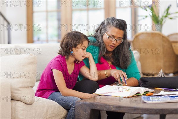 Mother helping daughter with homework