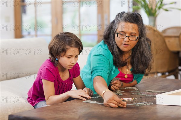 Mother and daughter putting puzzle together