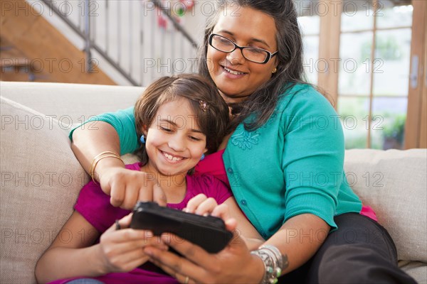 Mother and daughter using digital tablet