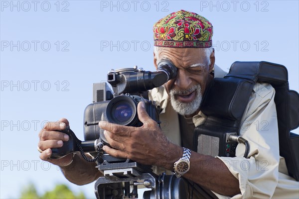 African American man using film camera