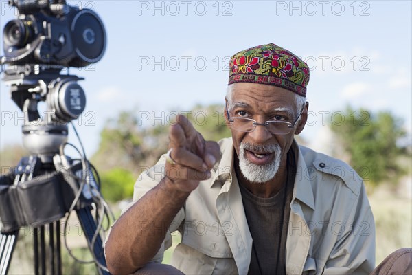 African American director near film camera