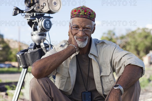 African American director near film camera