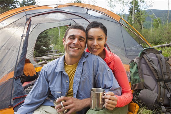 Smiling couple camping together