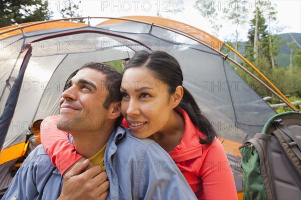 Smiling couple camping together