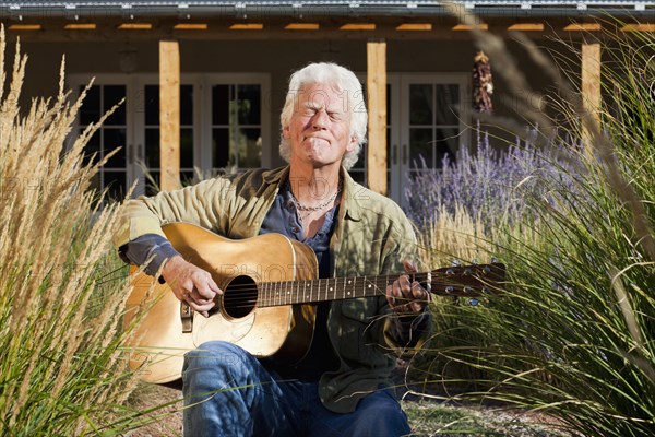 Caucasian man playing guitar