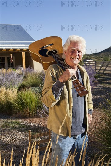 Caucasian man holding guitar