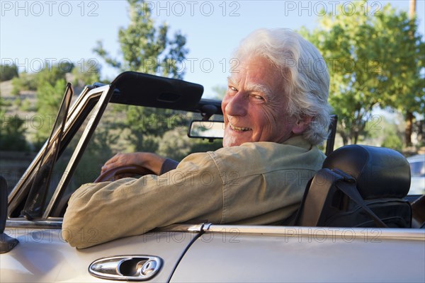 Caucasian man driving convertible