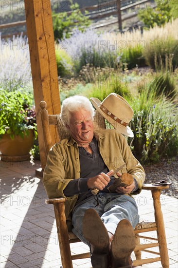 Caucasian man carving wood