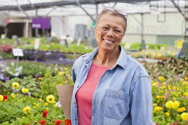 Mixed race woman working in plant nursery