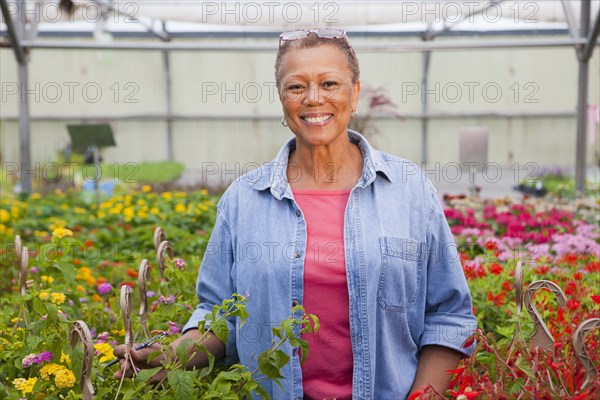 Mixed race woman working in plant nursery