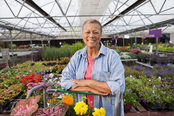 Mixed race woman working in plant nursery