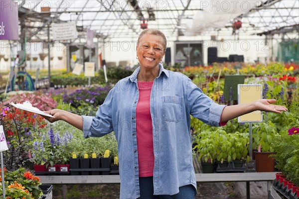 Mixed race woman working in plant nursery