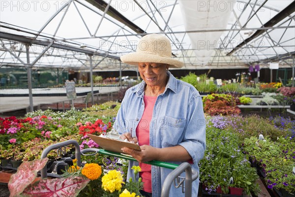 Mixed race woman working in plant nursery