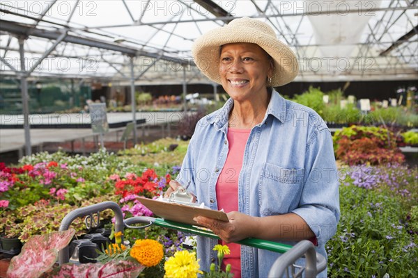 Mixed race woman working in plant nursery