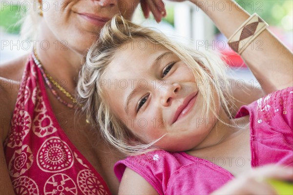 Caucasian mother and daughter sitting together