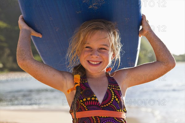 Caucasian girl holding paddle board