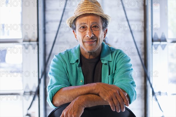 Older Caucasian man sitting in chair