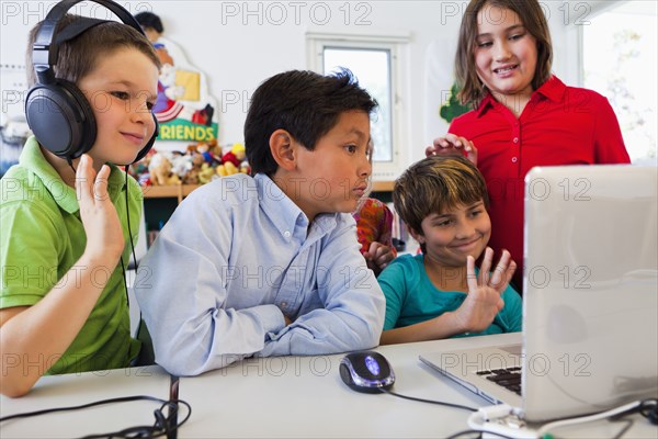 Students using laptop together