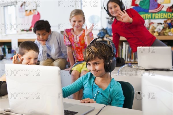 Students using laptops in classroom