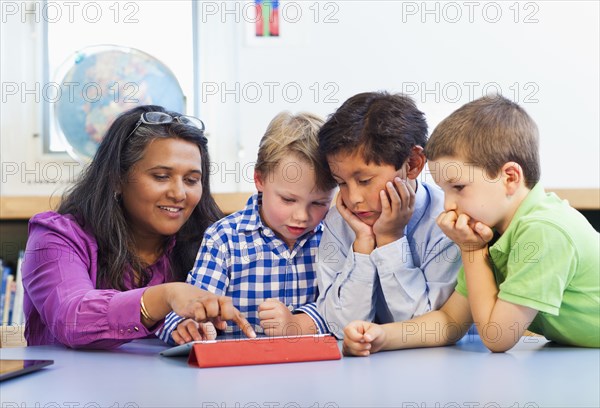 Teacher and students using digital tablet