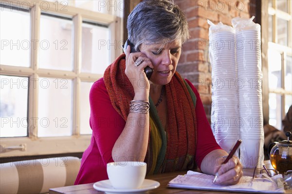 Caucasian businesswoman working in cafe