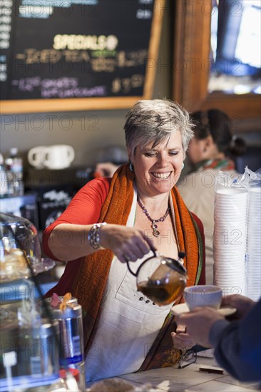 Caucasian woman working in coffee shop