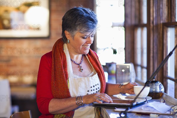 Caucasian woman working in coffee shop