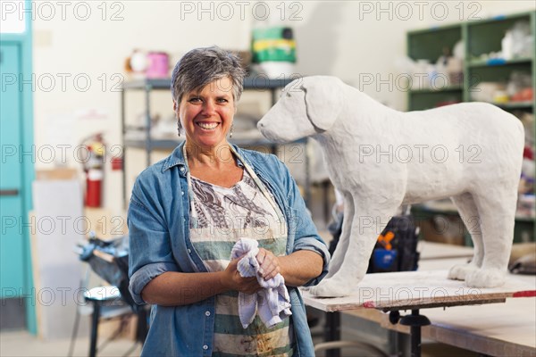 Caucasian sculptor working in studio