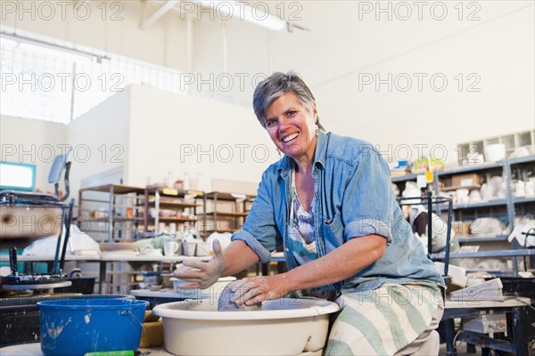 Caucasian sculptor working in studio