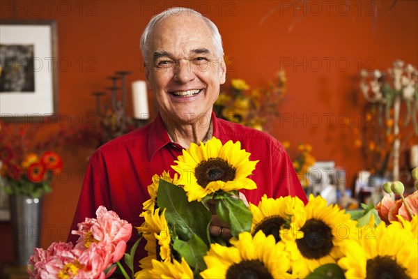 Caucasian florist with bouquet in shop