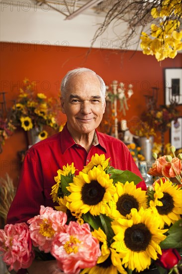 Caucasian florist with bouquet in shop