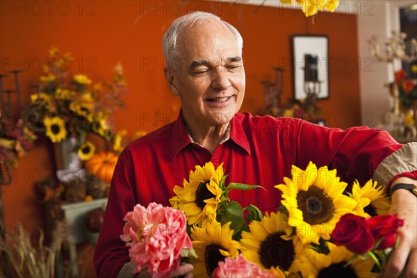 Caucasian florist with bouquet in shop