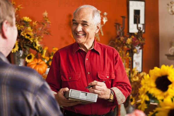 Caucasian florist taking orders in shop