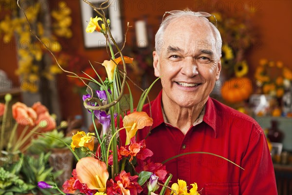 Caucasian florist with bouquet in shop