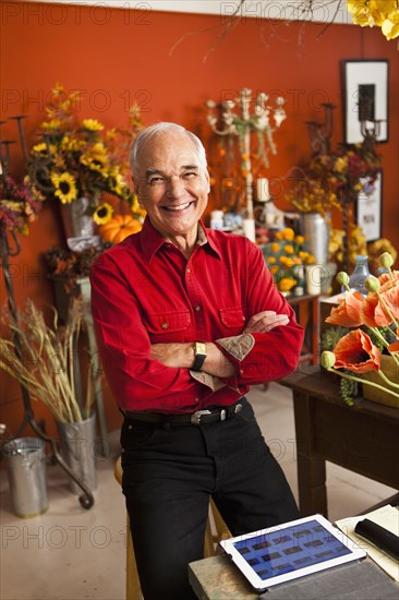 Caucasian florist using tablet computer in shop