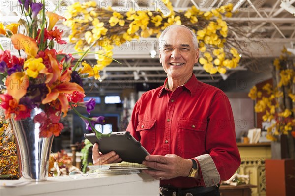 Caucasian florist using tablet computer in shop